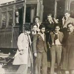 Karapet Hakobyan with friends standing in front of a train car