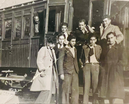 Karapet Hakobyan with friends standing in front of a train car